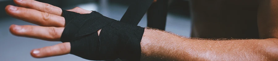 A person wrapping his hands in the ring