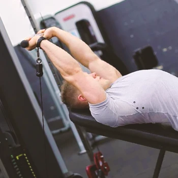 A person doing Incline Cable Skull Crusher workouts
