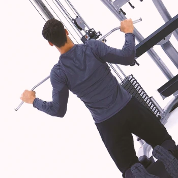 A person doing kneeling lat pulldowns at the gym