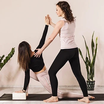 A woman being guided to do low lunge twist stretch