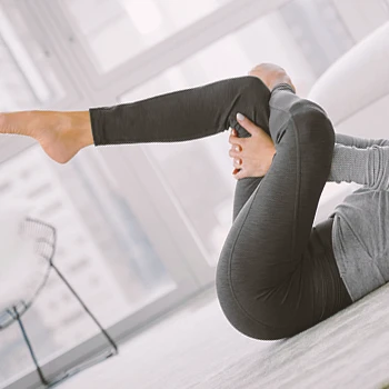 A person doing lying figure four stretches