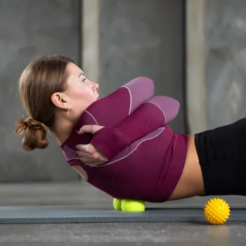 Person using a massage ball on lower back