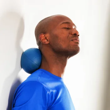 Person using a massage ball on neck