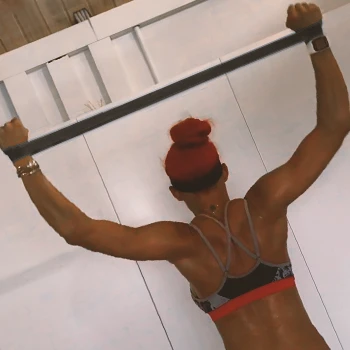 A person doing resistance band lat pulldowns