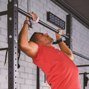 A person doing pull-ups at the gym