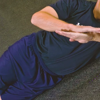 A person doing the posterior capsule stretch workout