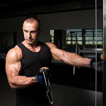 A man using the cable machine in his workout