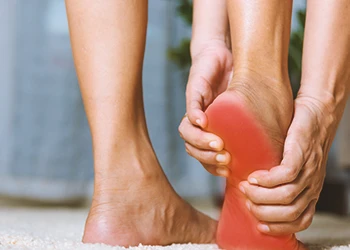 A woman holding out the sole of her feet