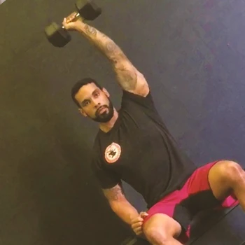 A person working out with a single arm Arnold press