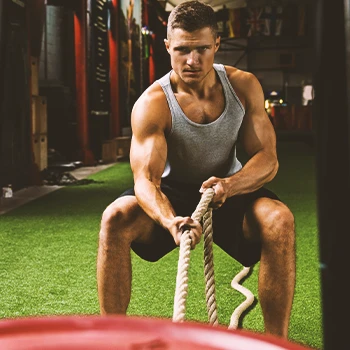 A person doing sled drag workouts at the gym