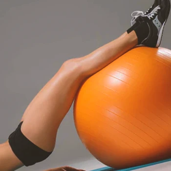 A person doing Stability Ball Hamstring Curl workouts