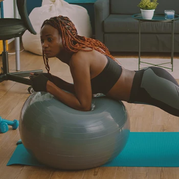 A woman doing swiss ball rollout workouts