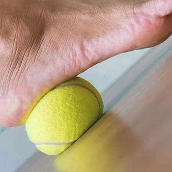 A person doing the tennis ball roll exercise