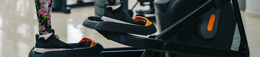 A close up shot of a person using a stair stepper