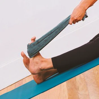 A person doing towel stretch workouts