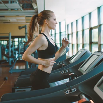 A person doing cardio at a treadmill as warm up