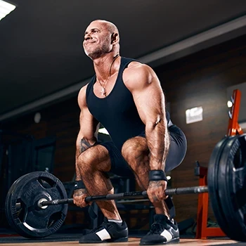A strong man doing deadlifts in the gym