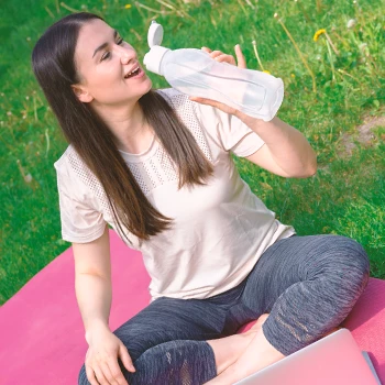 A person drinking Mind Vitality outside at a park