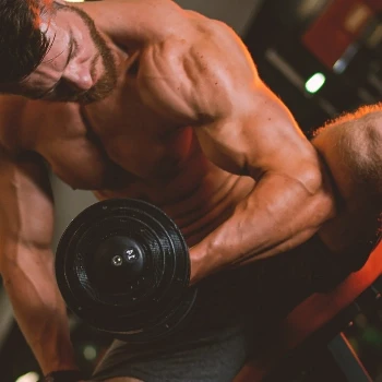A person working out his biceps and triceps at the gym
