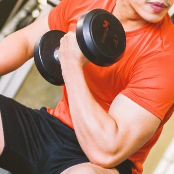 A person doing bicep curls at the gym