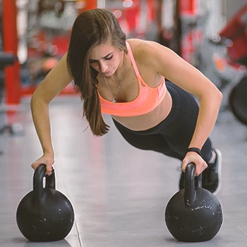 A person doing intense workout with kettlebells