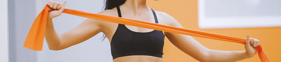 A woman holding a long resistance band