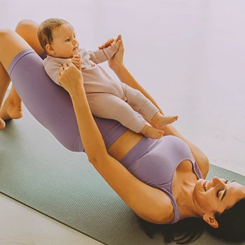 A mother doing workouts with her baby
