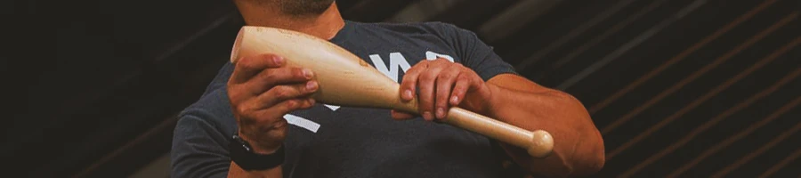 A person holding an Indian Club