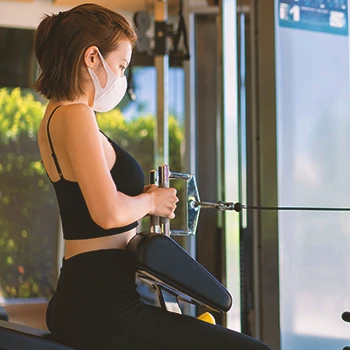 A person doing cable rows at the gym