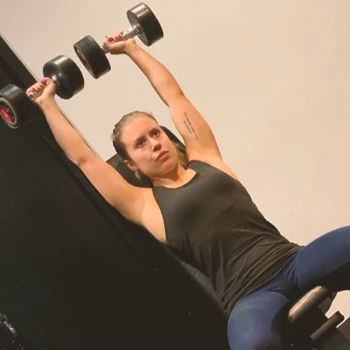 A person doing close grip shoulder press sit ups at the gym