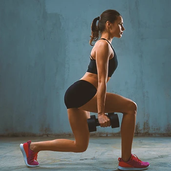 A person doing dumbbell lunges