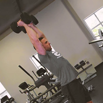 A person doing an overhead carry