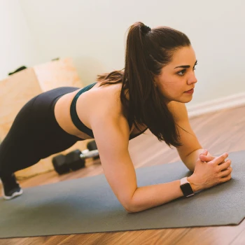 A person doing planks at a home gym