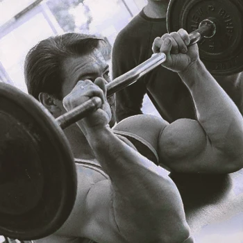 A person doing reverse preacher curls