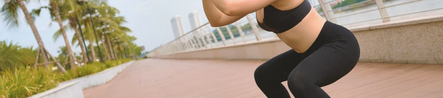 A person at the park doing squats