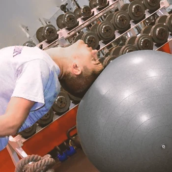 A person doing Stability Ball Neck Bridges