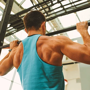 A person doing upper body strength workouts at the gym