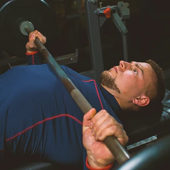 A person doing chest press workouts at the gym