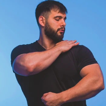 A person holding his shoulder muscles
