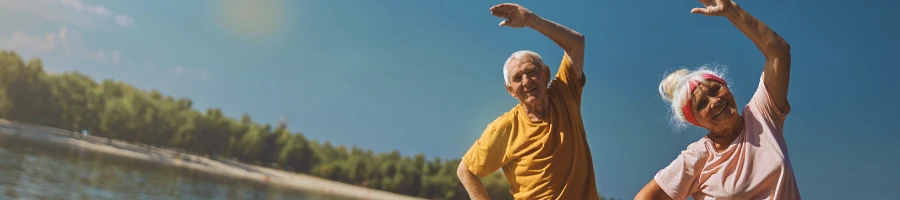 A senior couple working out outside