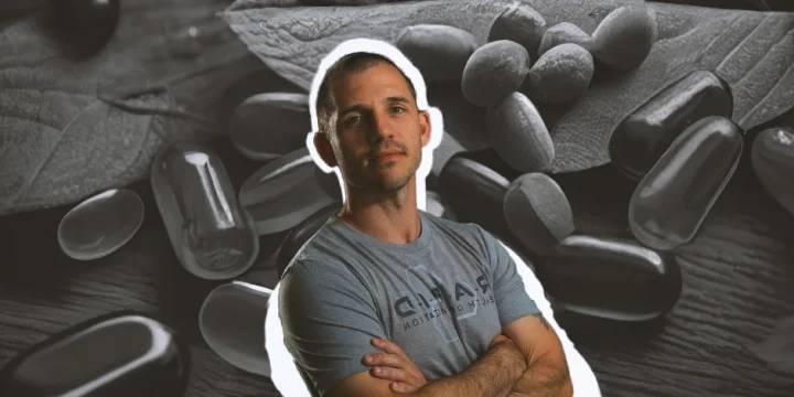 Andy Galpin posing for the camera with supplements at the background