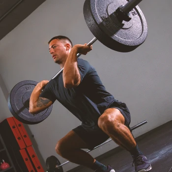 A person doing weight back squats