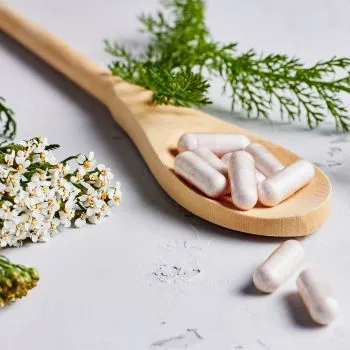 Close up of supplements on a wooden spoon