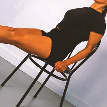 A person doing chair leg raises at home