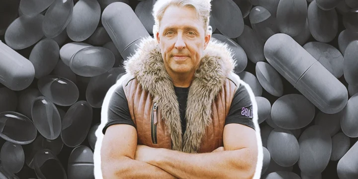 Dave Asprey posing in front of a bunch of supplements