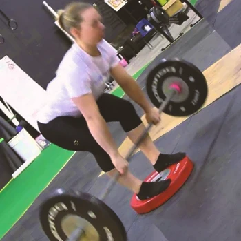 A person doing a Deficit Deadlift Stance