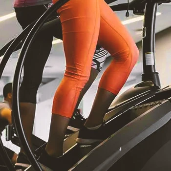 A person working out on a stairmaster at the gym