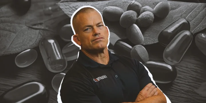 Jocko Willinks posing in front of supplements