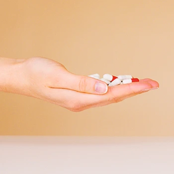 A person holding a bunch of low-dose aspirin