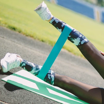 A person doing resistance band leg lifts